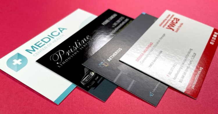Examples of business card paper finishes including gloss UV coating, matte aqueous coating, and soft-touch lamination on cardstock
